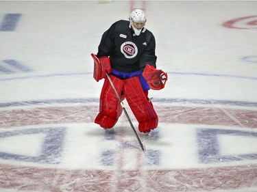 Carey Price catches a puck while standing at centre ice during Montreal Canadiens training camp practice at the Bell Sports Complex in Brossard on Wednesday, January 6, 2021.