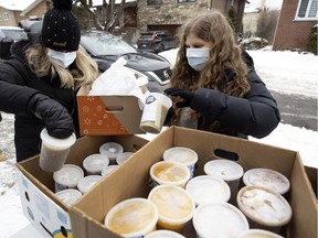 Aviva Orenstein Kalin and her daughter Rachel Kalin sort one-litre containers of frozen soup about to be delivered to health-care workers as part of the Souper Hero initiative.
