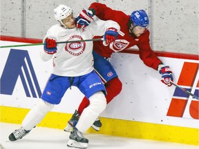 Noah Juulsen squeezes Josh Anderson against the end boards during the Montreal Canadiens training camp scrimmage at the Bell Sports Complex in Brossard on Thursday, Jan. 7, 2021.