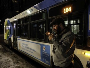 Bus driver John Daoust lights a pipe on Jan. 9, 2021, during the first night of Quebec's province-wide curfew.