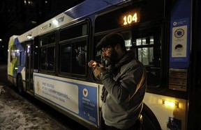 Bus driver John Daoust lights a pipe on Jan. 9, 2021, during the first night of Quebec's province-wide curfew.