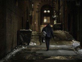 A homeless man walks in a lane near Ste-Catherine St. at Metcalfe St. on Saturday, January 9, 2021 in Montreal.
