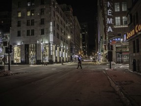 A homeless man crosses Ste-Catherine St. after curfew on Jan. 9, 2021.