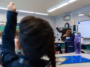 The EMSB showed off their newly installed air purifiers at Pierre Elliott Trudeau elementary school in Montreal on Monday January 11, 2021. The HEPA filter hangs from the wall in the background while principal Tanya Alvarez takes over a class at the elementary school.