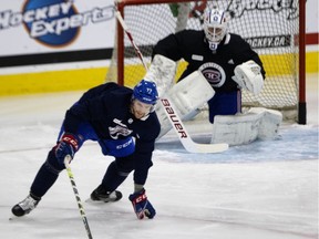 Montreal Canadiens defenceman Brett Kulak tries to deflect a shot during training camp in Brossard on Jan. 11, 2021.