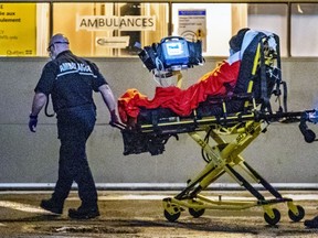 A paramedic wheels a patient into the emergency department at St. Mary's Hospital in Montreal on Tuesday evening January 12, 2021.