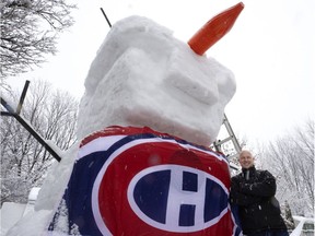Derek Parker with his giant Olaf Canadiens snowman in Montreal on Saturday, Jan. 16, 2021.
