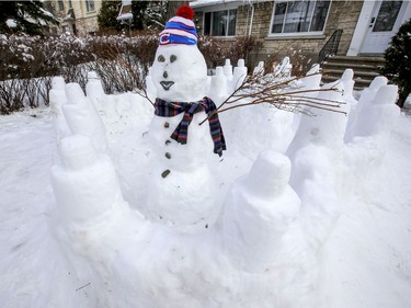 A snowman wearing a Montreal Canadiens toque in a snow fort is seen on the lawn of a home in the Lachine borough of Montreal on Jan. 18, 2021.