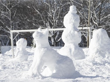 Snow sculptures, including a dog, along a path in Jeanne-Mance Park on Monday, Jan. 18, 202.