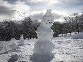 Snowman has a menacing look as he stands next to the paths of Jeanne-Mance park on Monday January 18, 2021 during the COVID-19 pandemic. People took advantage of the wet snow that fell over the weekend to go out and make snowmen all over town. (Pierre Obendrauf / MONTREAL GAZETTE) ORG XMIT: 65625 - 1108