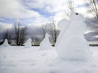 A squirrel snow sculpture leads a dog, dolphin and seal on the lakeshore in the Lachine borough of Montreal on Jan. 18, 2021.