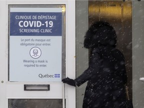 A woman enters the new COVID-19 testing facility at the Centre RioCan Kirkland shopping centre, west of Montreal on Jan. 21, 2021.
