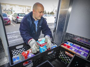 Milkman Joël Lefebvre prepares a delivery in Vaudreuil-Dorion, west of Montreal, on Tuesday, Jan. 19.