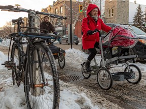 "I would never have imagined biking on St-Denis St. in the snow, at night, and feeling safe," says Zuemy Luna, with Xavier Vivier Julien and their baby, Julien Santiago Luna Vivier, on the Réseau express vélo bike path.