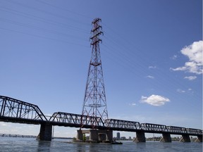 A Hydro-Québec tower looms behind the Victoria Bridge in Montreal.