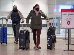 Passengers arrive at Montréal–Trudeau International Airport on flight from the United States on Jan. 26, 2021.
