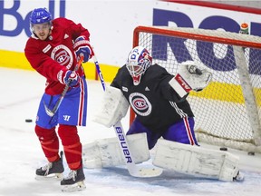 Jake Allen makes a glove save behind screen by Brendan Gallagher during Montreal Canadiens practice at the Bell Sports Complex in Brossard on Jan. 27, 2021.
