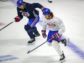 Ben Chiarot, rear, pursues Josh Anderson during Montreal Canadiens practice at the Bell Sports Complex in Brossard on Jan. 27, 2021.