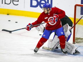 MONTREAL, QUE.: JANUARY 27, 2021 -- Brendan Gallagher tips a shot in front of Charlie Lindgren during Montreal Canadiens practice at the Bell Sports Complex in Brossard on Wednesday January 27, 2021.  (John Mahoney} / MONTREAL GAZETTE) ORG XMIT: 65667 - 7718