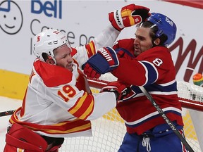 Canadiens' Ben Chiarot (8) gets the gloves up high with Calgary Flames' Matthew Tkachuk (19)during third period NHL action in Montreal on Thursday, Jan. 28, 2021. Both were sent to the penalty box.