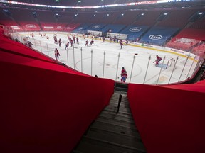 The Montreal Canadiens and the Calgary Flames warm up prior to home opener in Montreal on Jan. 28, 2021.