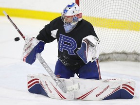 Laval Rocket goalie Cayden Primeau makes a blocker save during practice in Laval on March 3, 2020.