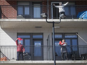 Seniors participate in an outdoor Zumba class from the balcony of a residence in Blainville last March. Public health messages should include advice on simple, affordable and accessible ways to stay active during the pandemic, Jill Barker writes.