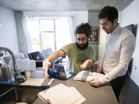 Nader Baydoun, left, and his brother Naji in their condo near the Quartier des Spectacles.