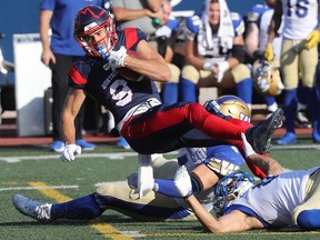Montreal Alouettes' Jake Wieneke is brought down by the Winnipeg Blue Bombers during first half in Montreal on Sept. 21, 2019.