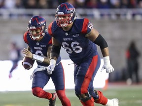 Montreal Alouettes offensive-lineman Trey Rutherford leads the blocking for quarterback Vernon Adams Jr. during a game against the Calgary Stampeders in Montreal on Oct. 5, 2019.