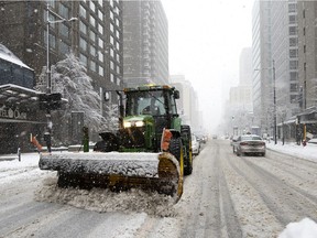 Snow-removal crews clear Sherbrooke St. in Montreal on Saturday, Jan. 16, 2021.