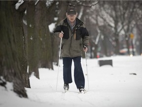 Eighty-four year-old  Georges Blanchet gets on his cross-country skis for the first time of the year, along Côte-des-Neiges Rd.