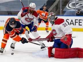 Oilers' Kailer Yamamoto  battles Canadiens' Jeff Petry and goaltender Carey Price at Rogers Place on Saturday, Jan. 16, 2021, in Edmonton.