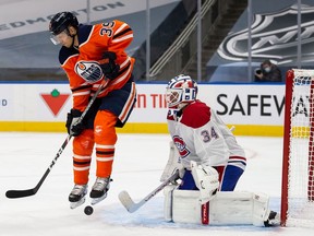 Alex Chiasson of the Edmonton Oilers battles against goaltender Jake Allen of the Montreal Canadiens at Rogers Place in Edmonton Jan. 18, 2021.