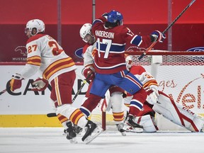 Mark Giordano #5 of the Calgary Flames defends against Josh Anderson #17 of the Montreal Canadiens during the third period at the Bell Centre Jan. 28, 2021 in Montreal.  The Canadiens defeated the Calgary Flames 4-2.