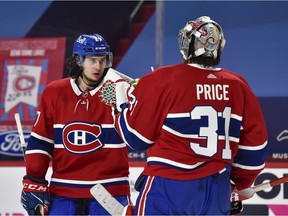 Montreal Canadiens rookie defenceman Alexander Romanov celebrates a victory over the Calgary Flames with goaltender Carey Price at the Bell Centre on Jan. 28, 2021, in Montreal.