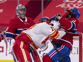 Canadiens defenceman Ben Chiarot battles with Calgary Flames forward Matthew Tkachuk while goalie Carey Price looks on during third-period action at the Bell Centre Thursday night.