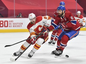 Canadiens' Shea Weber (6) defends against Elias Lindholm (28) of the Calgary Flames during the first period at the Bell Centre on Saturday, Jan. 30, 2021, in Montreal.