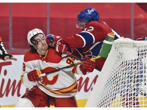 Canadiens' Jonathan Drouin (92) plays rough with Andrew Mangiapane (88) of the Calgary Flames during the first period at the Bell Centre on Saturday, Jan. 30, 2021, in Montreal.