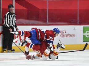 MONTREAL, QC - JANUARY 30:  Tomas Tatar #90 of the Montreal Canadiens collides with Nikita Nesterov #89 of the Calgary Flames during the third period at the Bell Centre on January 30, 2021 in Montreal, Canada.  The Calgary Flames defeated the Montreal Canadiens 2-0.