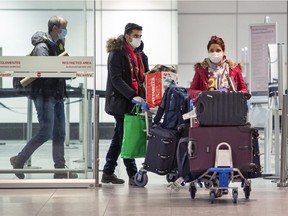 MONTREAL, QUE.: DECEMBER 30, 2020 -- Passengers arrive at Montréal-Pierre Elliott Trudeau International Airport in Montreal Wednesday December 30, 2020. (John Mahoney / MONTREAL GAZETTE) ORG XMIT: 65542 - 5724