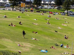 People are seen sun bathing at Bondi Beach in Australia in December.