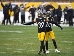 Safety Minkah Fitzpatrick (39) and cornerback Cameron Sutton (20) of the Pittsburgh Steelers react after an incomplete pass on fourth down and eight by the Indianapolis Colts to turn over the ball on downs in the fourth quarter of their game at Heinz Field on Dec. 27, 2020, in Pittsburgh. The Steelers defeated the Colts 28-24.