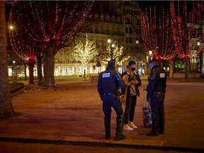 Police enforce France's strict 8pm curfew on the Champs Elysees on New Years eve