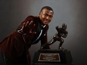 Wide-receiver DeVonta Smith of the Alabama Crimson Tide poses with the Heisman Memorial Trophy on Jan. 5, 2021, in New York City.