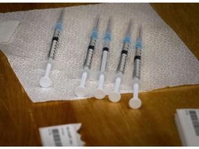 Five doses of the Pfizer-BioNTech COVID-19 vaccine are ready to be administered to health-care workers in Jan. 8, 2021.