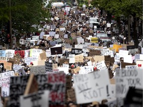 Thousands of people stream down Bleury Street as they take part in an anti racism and police brutality march in Montreal, on Sunday, June 7, 2020.