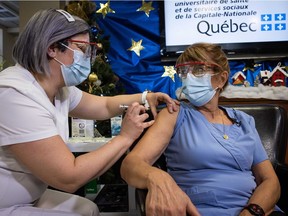 Danielle Marceau, a worker at CHSLD Saint-Antoine in Quebec City, receives a first dose of the COVID-19 vaccine on Dec. 14, 2020.