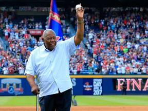 FILE - JANUARY 22, 2021: It was reported that legendary Atlanta Brave and Major League Baseball record holder Hank Aaron died Friday at the age of 86 January 22, 2021. ATLANTA, GA - OCTOBER 02: Hall of Famer Hank Aaron throws out the ceremonial last pitch at Turner Field to Bobby Cox after the game between the Atlanta Braves and the Detroit Tigers at Turner Field on October 2, 2016 in Atlanta, Georgia.