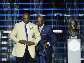 Floyd Little and his presenter, son Marc, look on during the 2010 Pro Football Hall of Fame Enshrinement Ceremony at the Pro Football Hall of Fame Field at Fawcett Stadium on Aug. 7, 2010, in Canton, Ohio.
